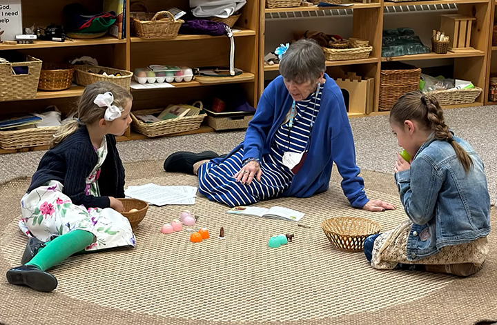 Children gathered in a circle for a Godly Play story time in the Trinity undercroft